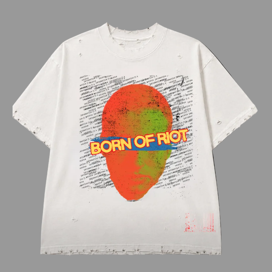 A white distressed t-shirt with a colorful graphic print featuring a red and green oval, a blue banner with 'BORN OF RIOT' in yellow, and a background of black text, shown against a solid black background.